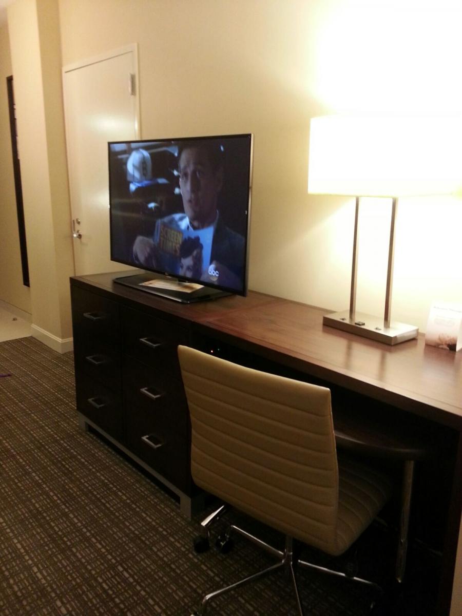 Office desk, office chair and TV at Rotary House International Hotel, MD Anderson